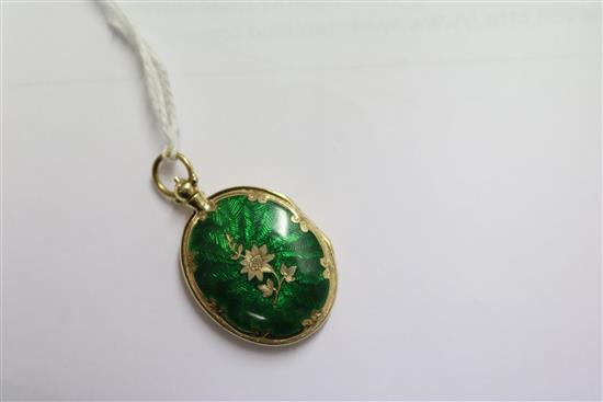 A 15ct gold and green enamel oval locket pendant, 30mm.